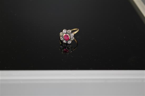 A yellow and white metal, ruby and diamond set oval cluster ring, (adapted),